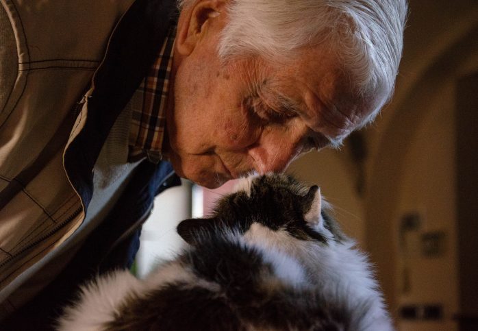 older man with cat