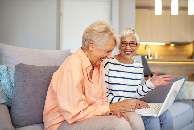 two women on computer laughing