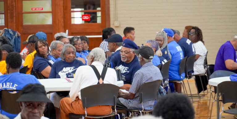 seniors sitting at tables in conversation