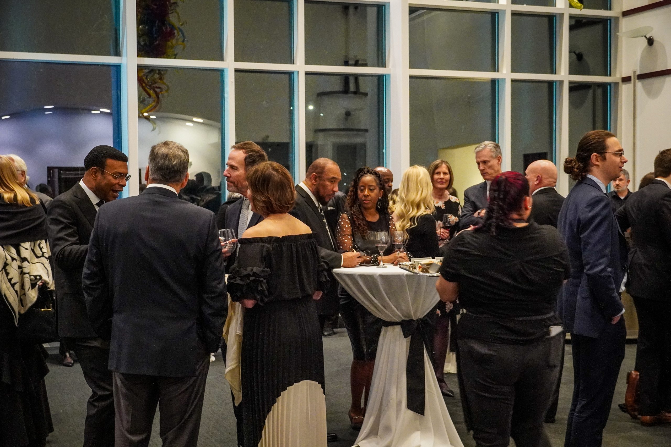 group of people in cocktail room wearing black and white attire