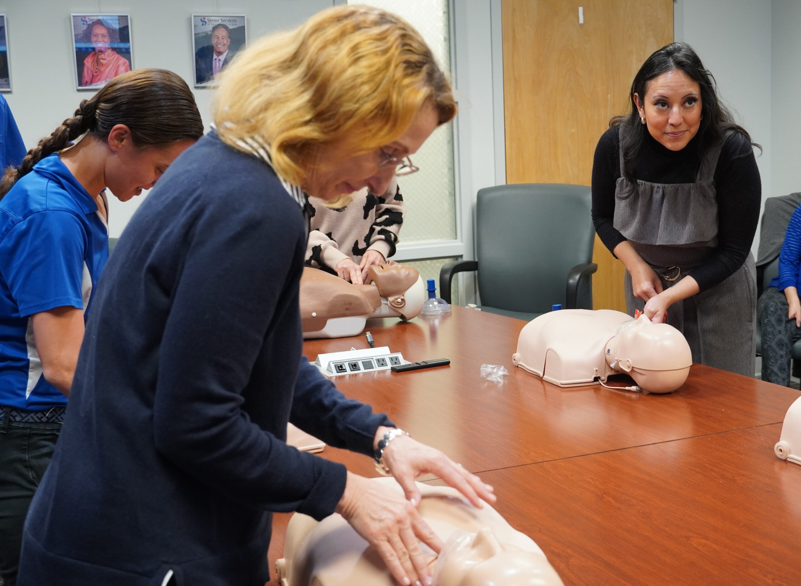 Three females working on CPR dummies