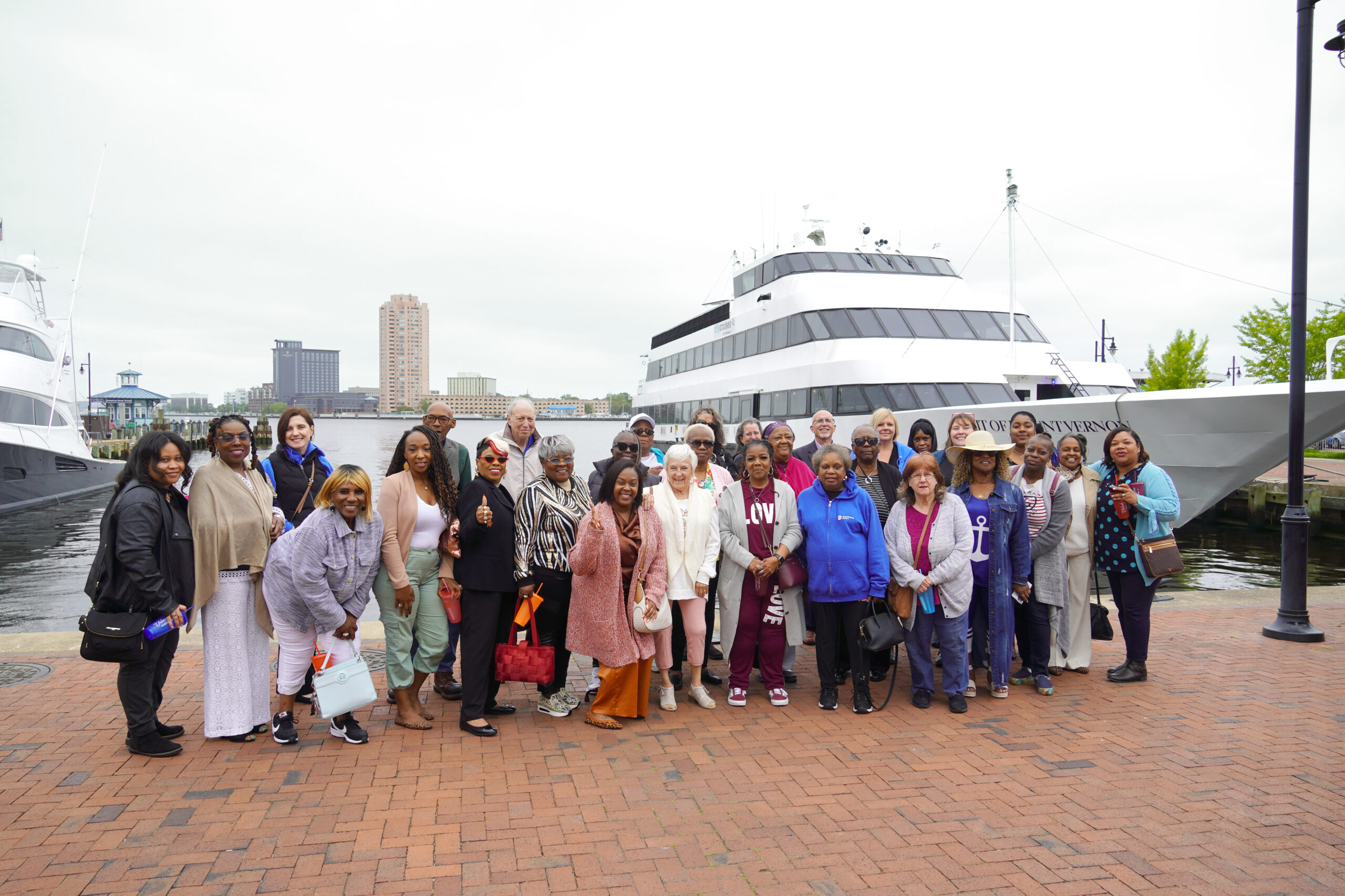 group photo of volunteers in front of cruise boat