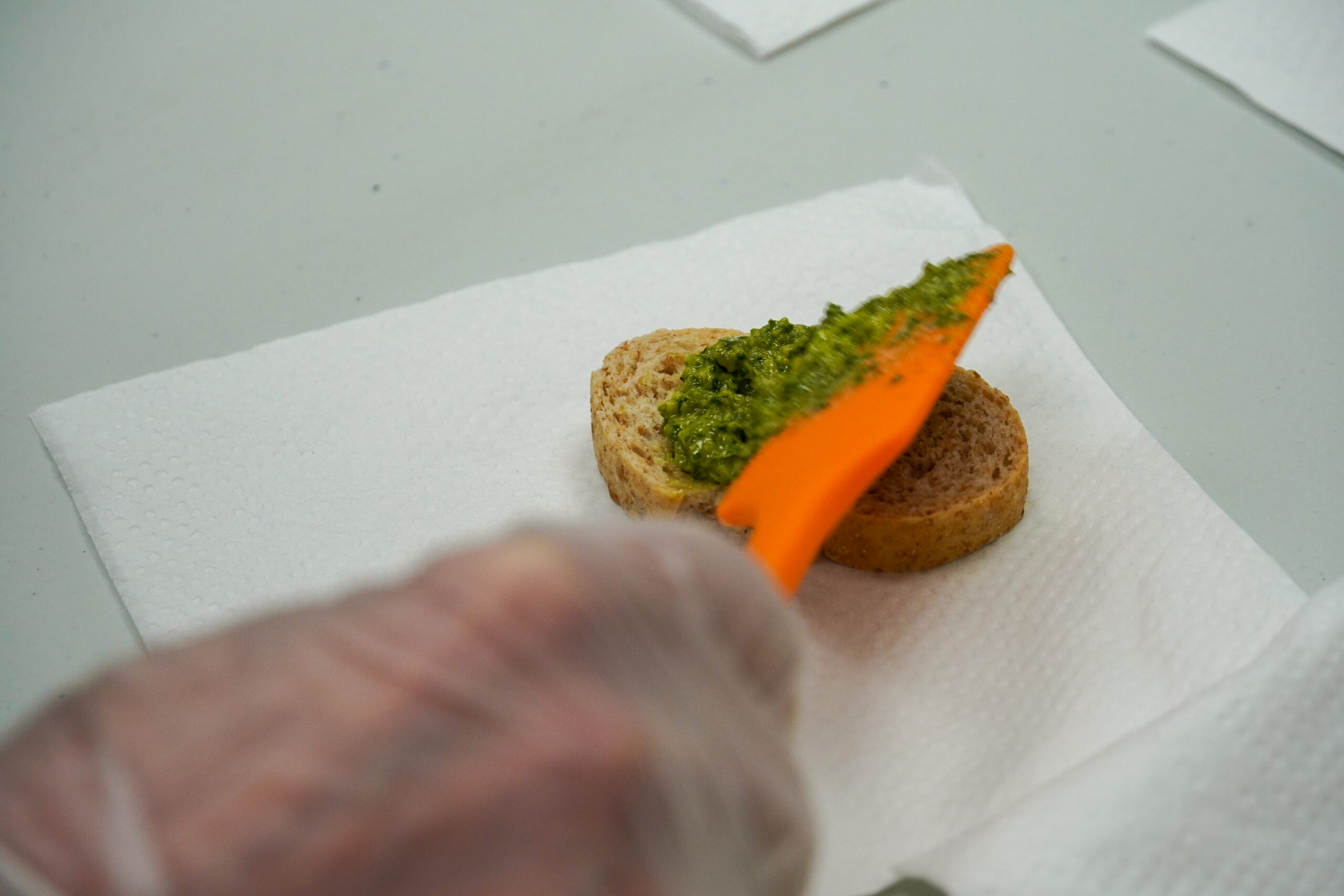 kale pesto being spread onto bread