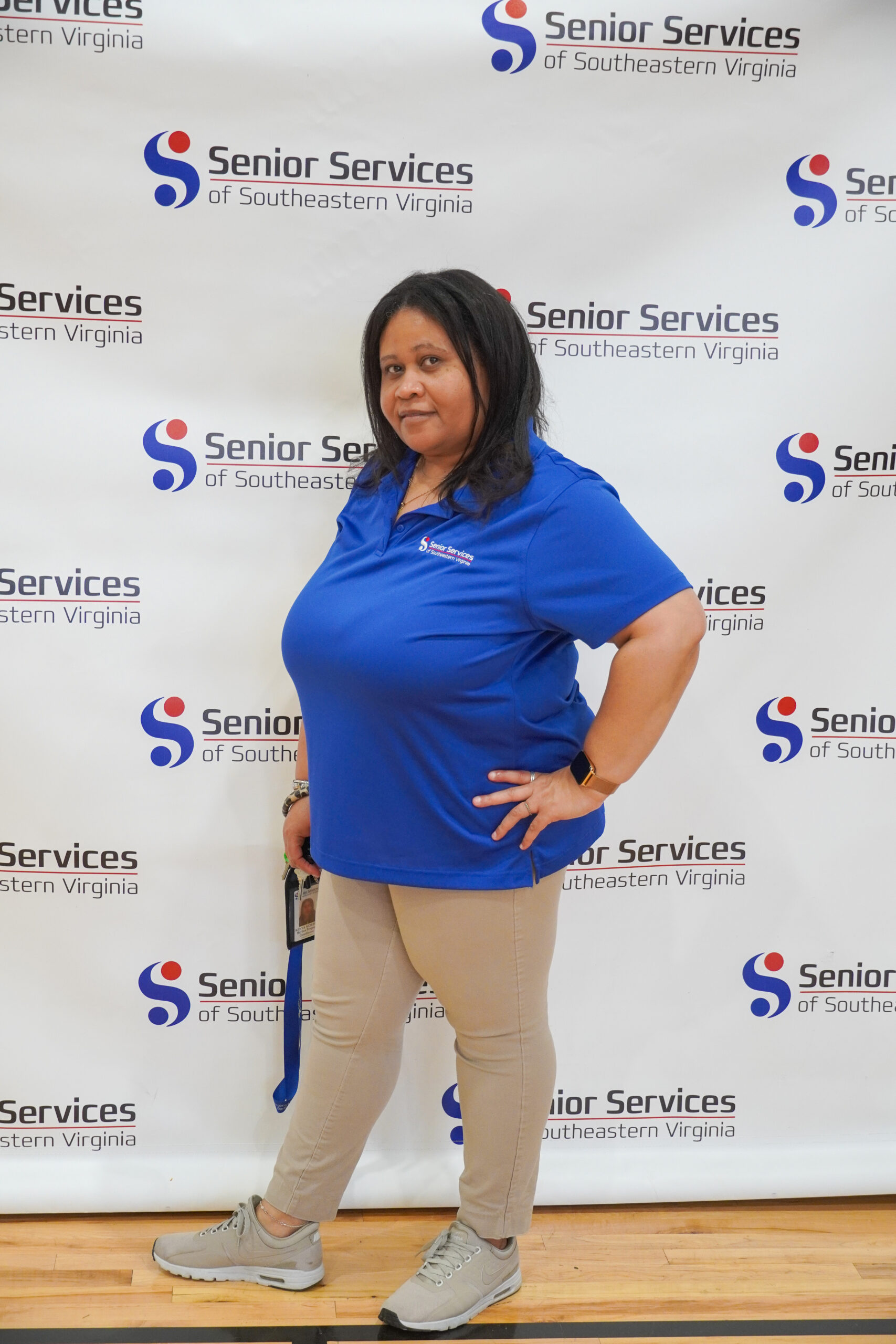 woman posing for camera with senior services background