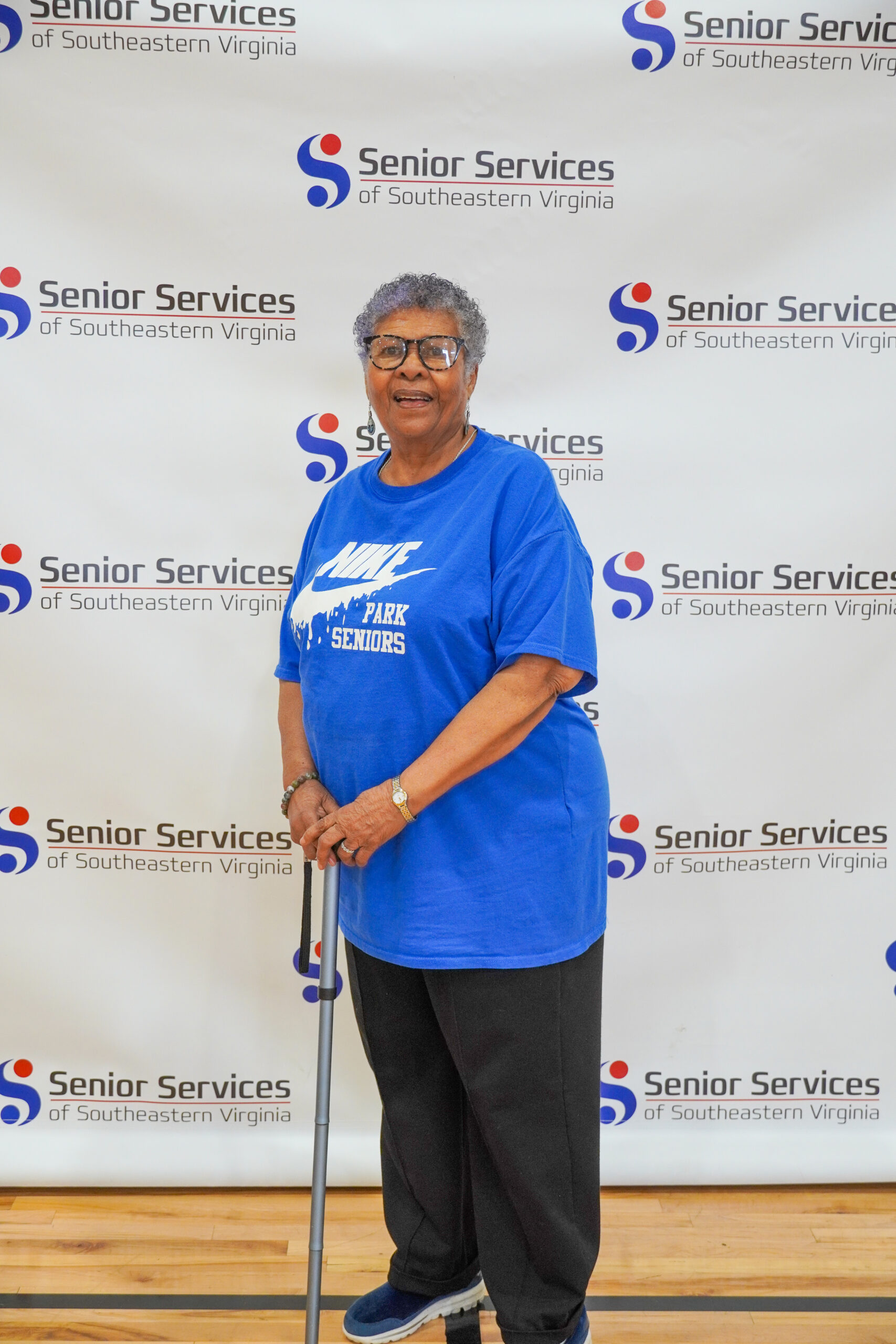 woman posing for camera with senior services background