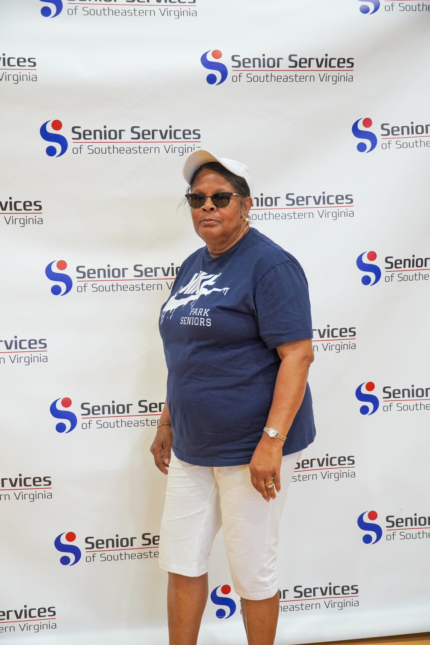 woman posing for camera with senior services background