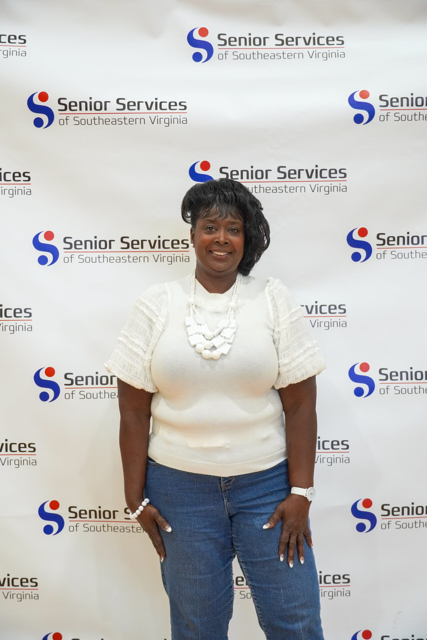 woman posing for camera with senior services background