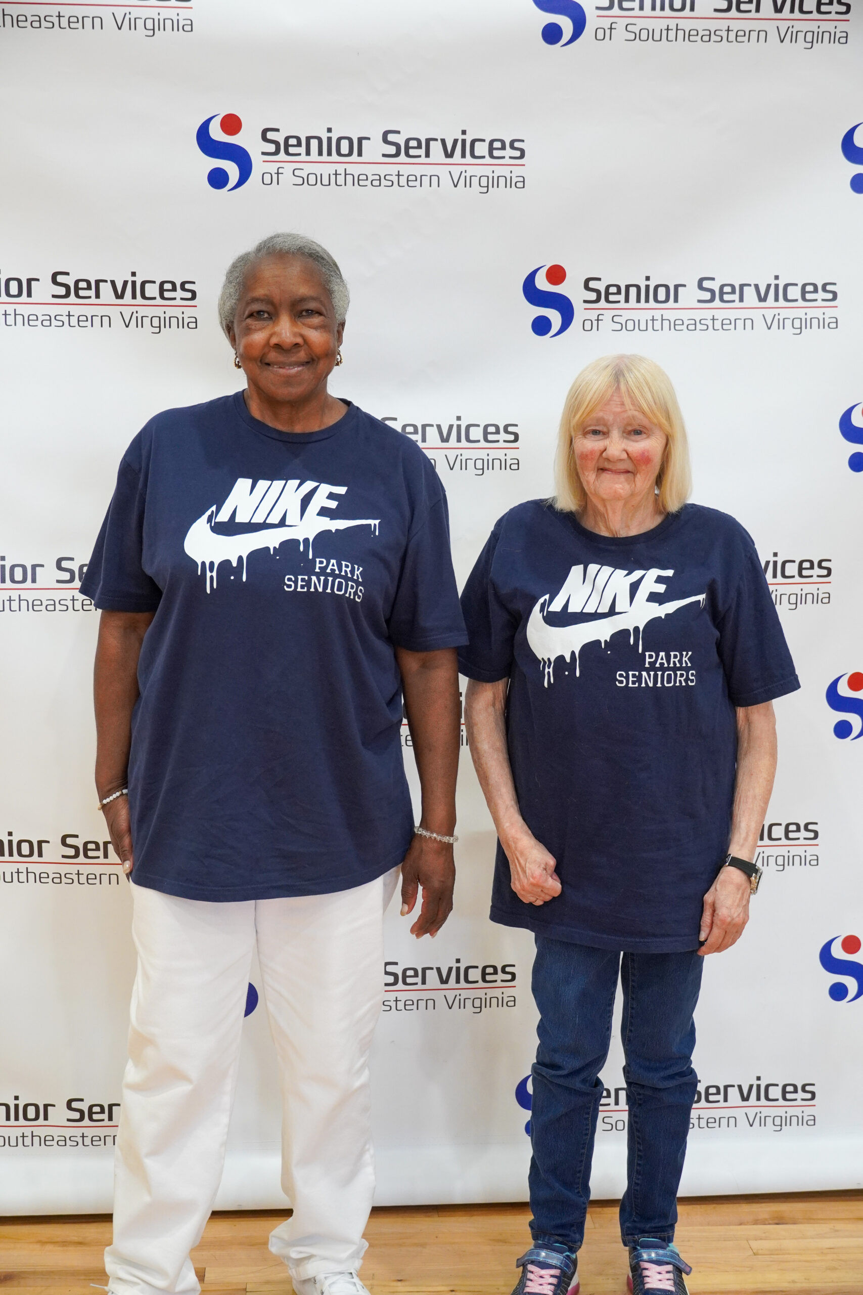 women posing for camera with senior services background