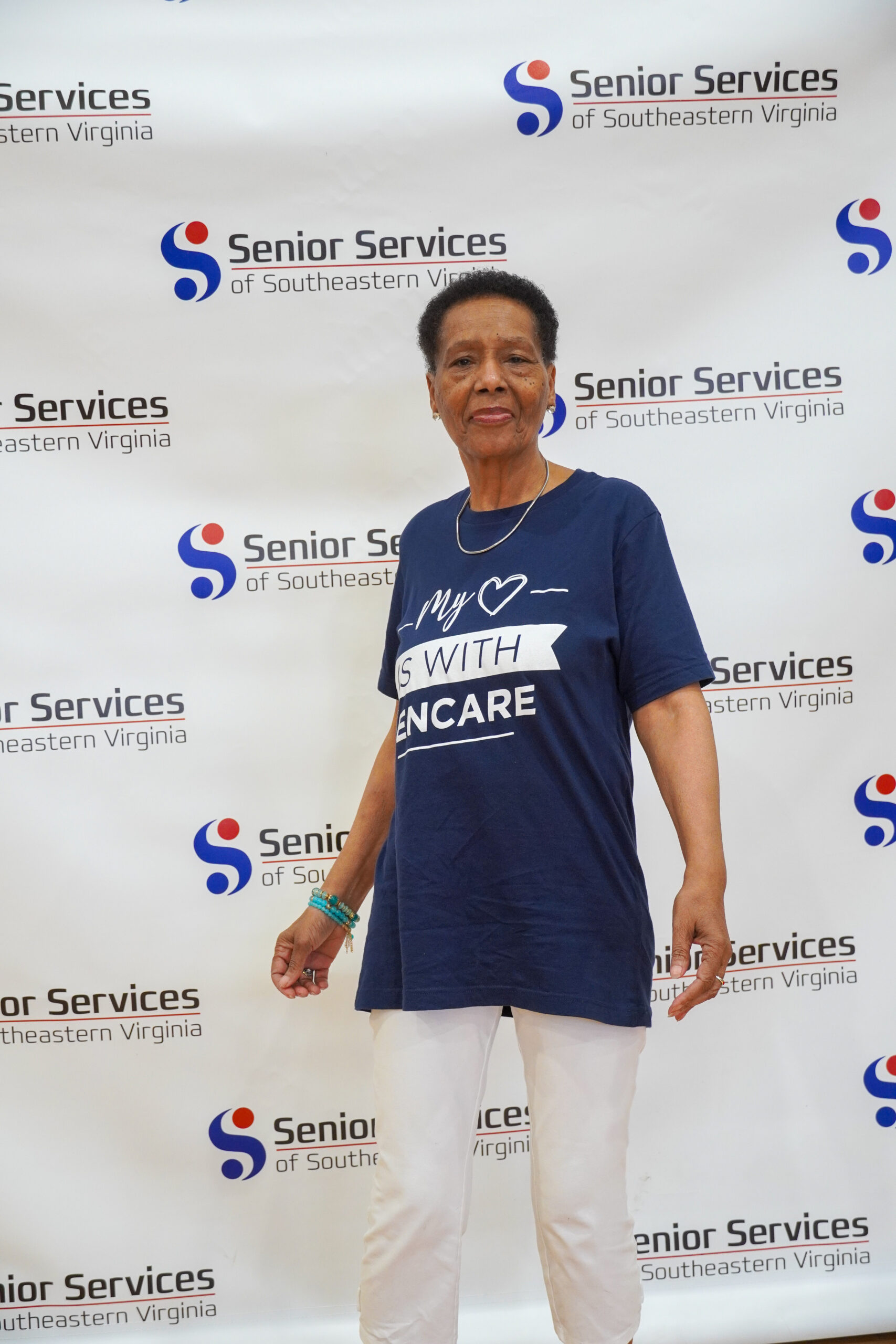 woman posing for camera with senior services background