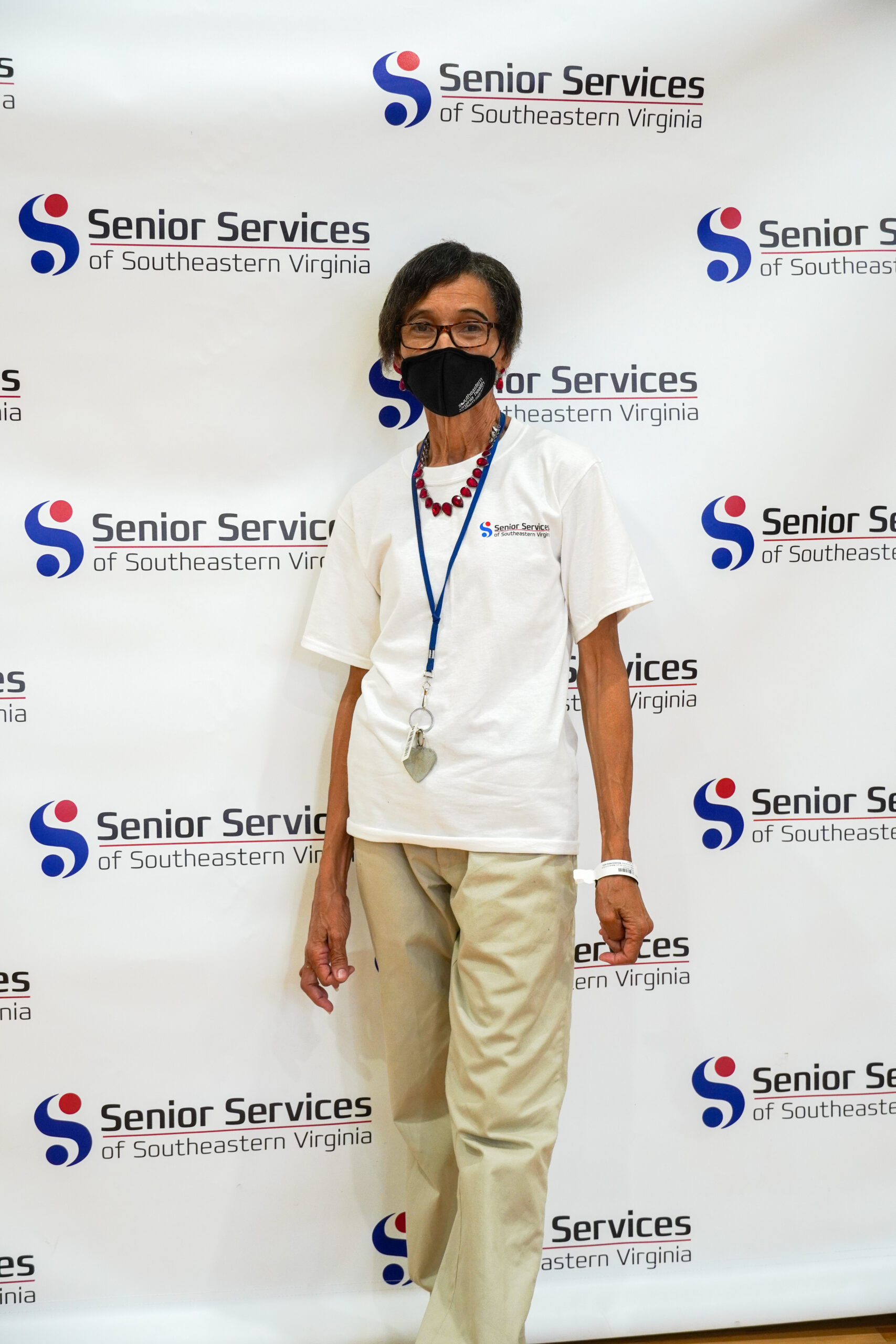 woman posing for camera with senior services background