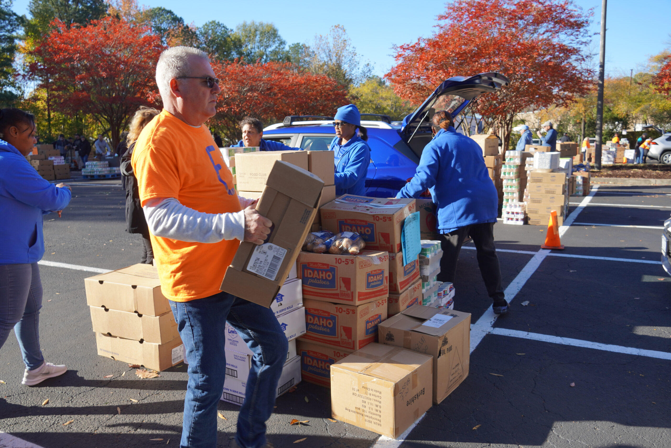 man in orange shirt moving boxes