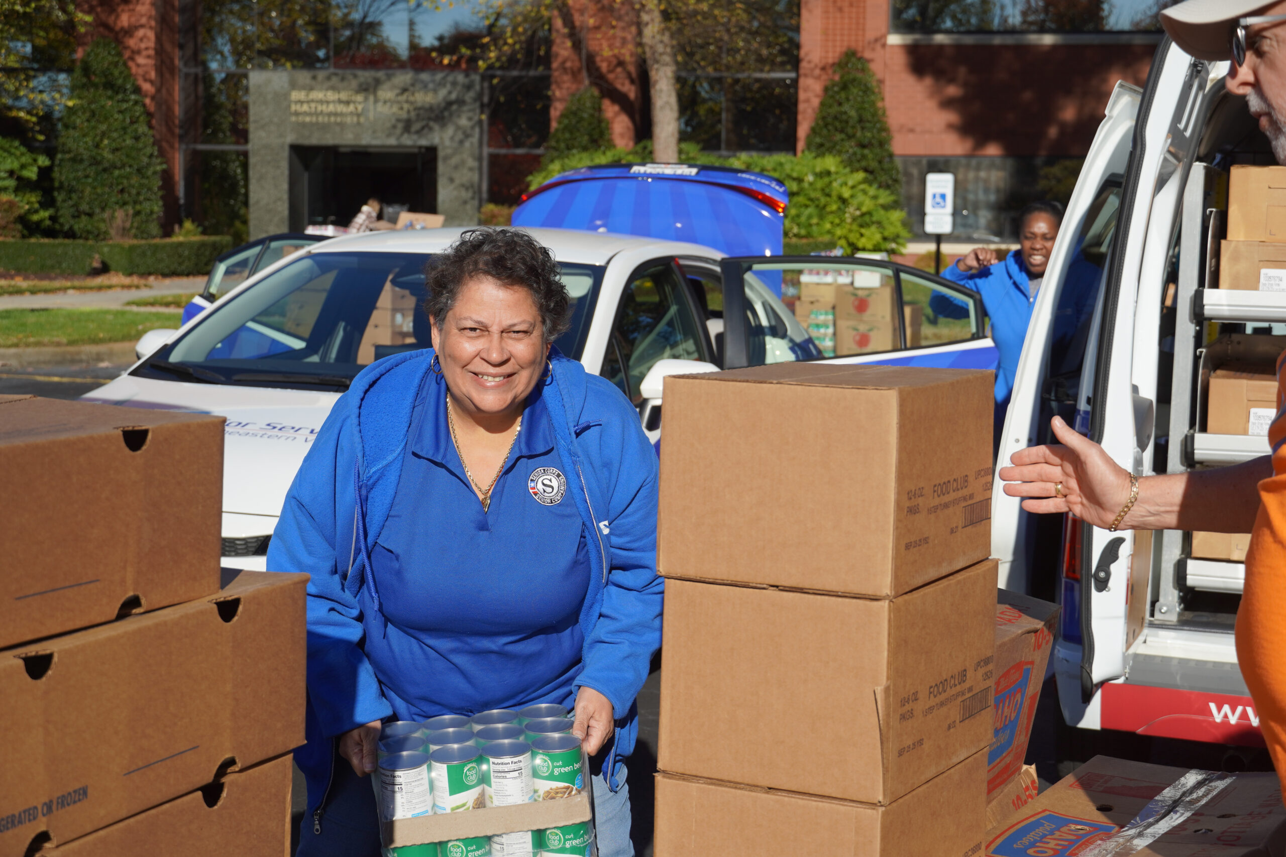 woman smiling while lifting cans