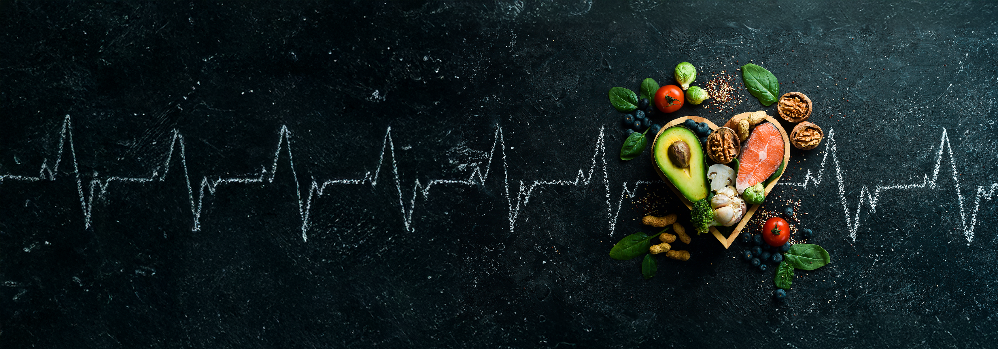 Food banner. Healthy foods low in carbohydrates. Food for heart health: salmon, avocados, blueberries, broccoli, nuts and mushrooms. On a black stone background.