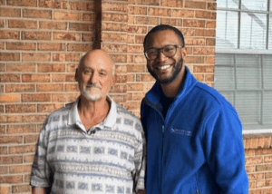 men standing outside of brick building