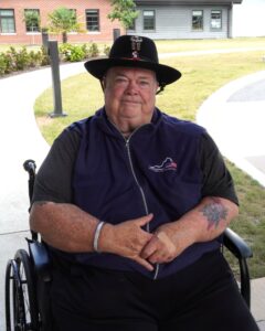 Kevin in his wheelchair smiling