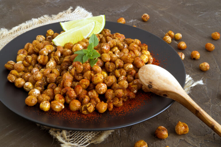 Roasted spicy chickpeas on a rustic on black plate