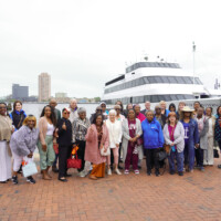 group photo of volunteers in front of cruise boat